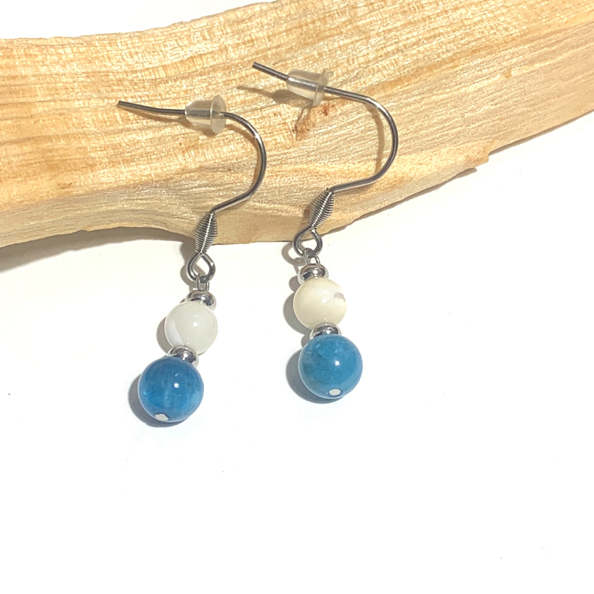  Boucles d'oreilles pendantes en acier inoxydable, sublimées par l'association harmonieuse de l'Apatite et de la Nacre. L'Apatite stimule la clarté mentale et la communication, tandis que la Nacre apporte douceur et apaisement