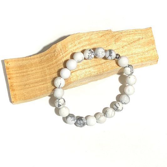 Ce bracelet en howlite 6mm, d’un blanc marbré élégant, favorise l’apaisement, la patience et la clarté d’esprit. Une pierre idéale pour calmer le mental et encourager la sérénité